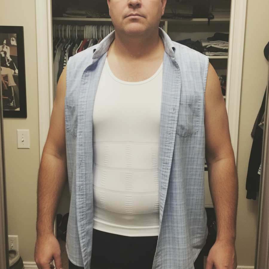 Closet mirror selfie wearing a white Terdanta Sculpt vest under an open button-up