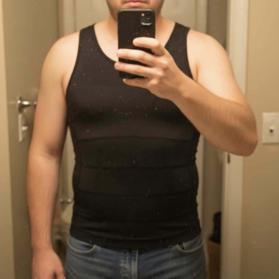 Bathroom mirror selfie showing a black Terdanta Sculpt compression vest