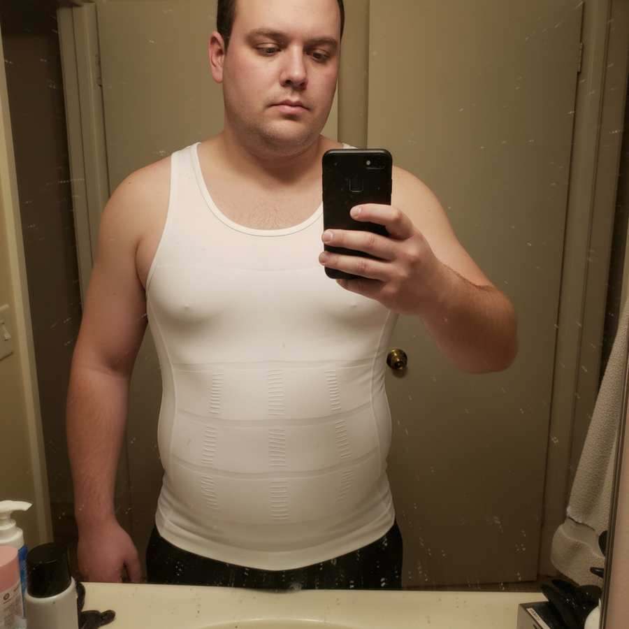 Close-up bathroom selfie in a white Terdanta Sculpt compression vest